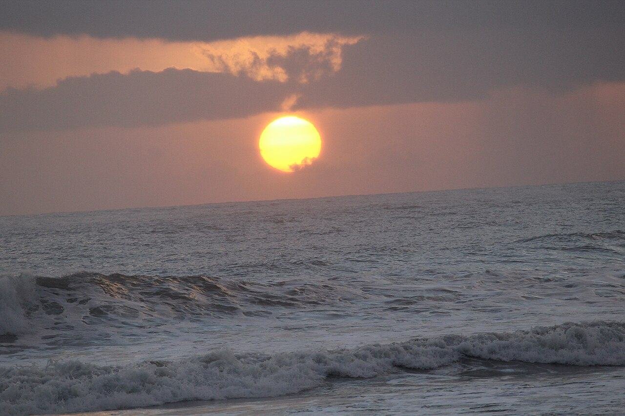 The sun setting over the sea at Malvan